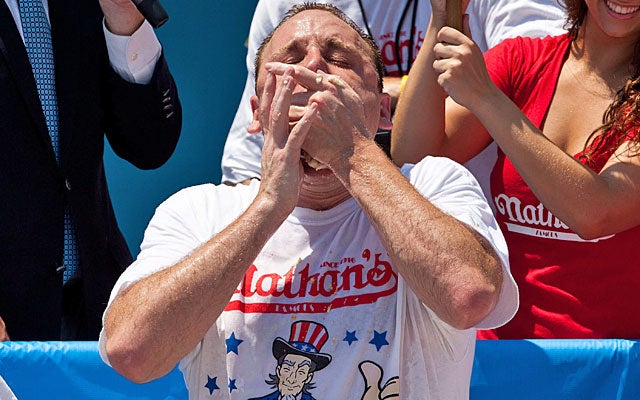 Joey Chestnut goes all out to match his own record with 68 hot dogs at the annual competition. (Getty Images)
