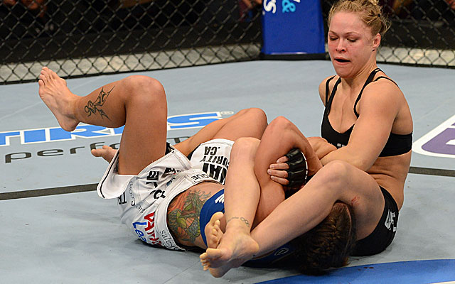 Ronda Rousey beats Liz Carmouche with an armbar in the first round of their match. (Getty Images)