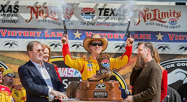 Joey Logano fires pistols Texas-style after winning the Duck Commander 500. (USATSI)