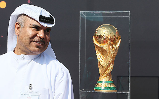 A Qatari official poses with the World Cup trophy during a tour last year.  (Getty)