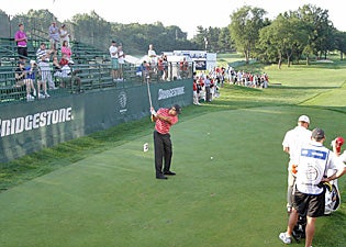 It's a lonely tee box as Tiger Woods gets ready to begin his final round at Firestone on Sunday. (AP)