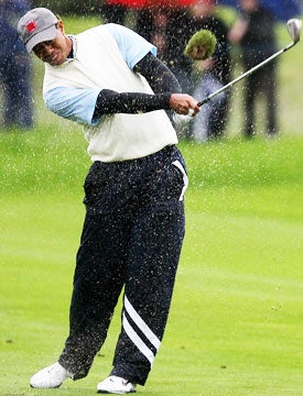 For most of the morning, Tiger Woods didn't even bother with half of his U.S.-issued raingear. (Getty Images)