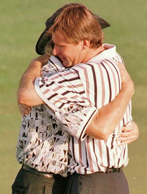 Greg Norman needed a hug after yielding an astounding 11 shots to Nick Faldo. (Getty Images)