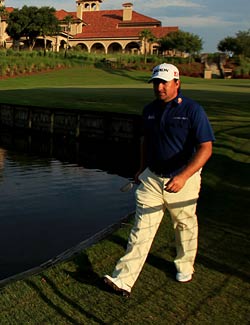 Graeme McDowell walks to the first tee as the sun begins to set at TPC Sawgrass. (Getty Images)