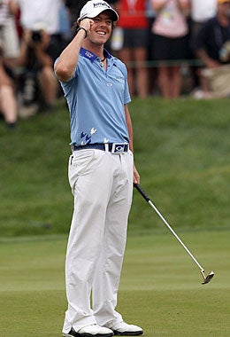 Rory McIlroy caps his superb tournament Sunday with a short putt. (Getty Images)