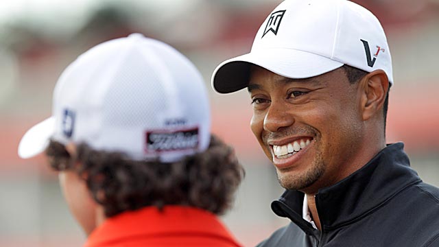 Woods shares a laugh with Rory McIlroy during a practice round Tuesday. (Getty Images)