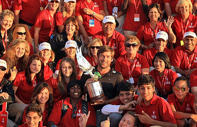 That's Robert Rock with the championship trophy in a sea of volunteers in Abu Dhabi. (Getty Images)