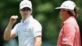 Zach Jonson and Jason Dufner talk while walking up the second fairway on Sunday. 