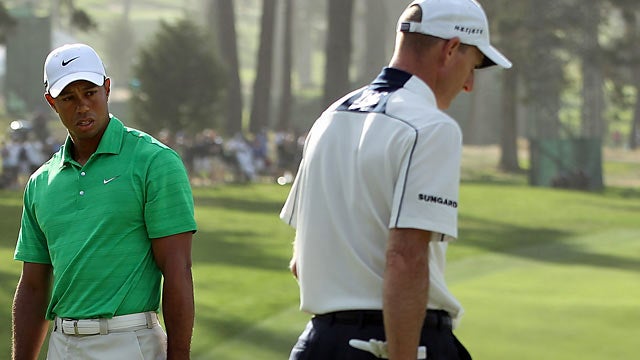 Woods and Jim Furyk go in different directions as only one holds his spot atop the leaderboard. (Getty Images)