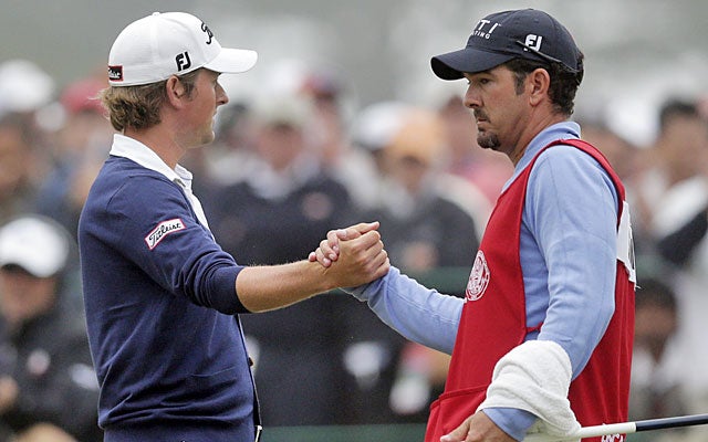 Webb Simpson accepts congratulations from his caddie after salvaging par on No. 18. (AP)
