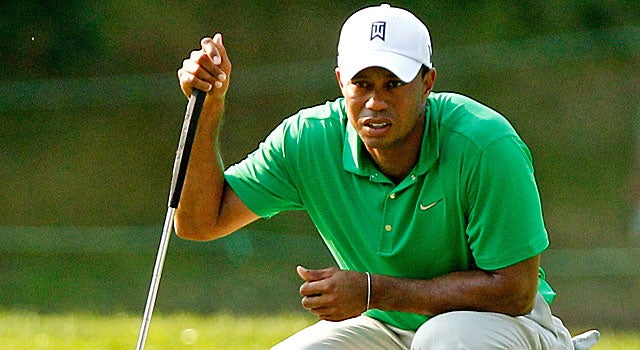 Tiger Woods shoots a 4-under 67 to share second place with Bo Van Pelt and Seung-Yul Noh. (US Presswire)