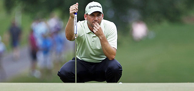 Sergio Garcia sizes up a putt on the 18th green during the third round. (AP)