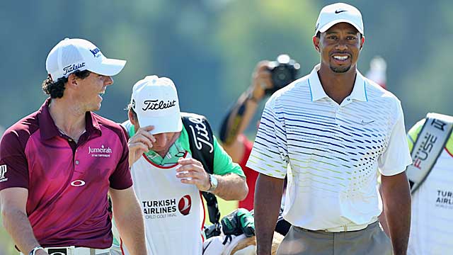 McIlroy shares a laugh with Woods during their match Thursday. (Getty Images)