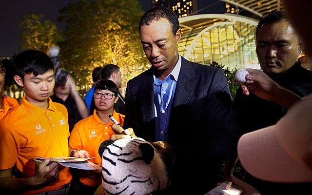 Woods, here in Singapore for a round of golf clinics, is among five nominated for POY honors. (AP)