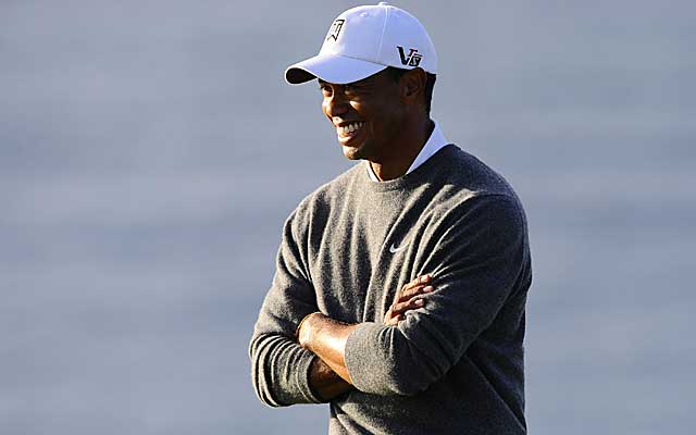 Tiger Woods has reason to smile, leading the suspended Farmers Insurance Open by six strokes. (US Presswire)