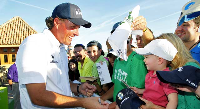 Phil Mickelson puts on a show for the biggest crowd in golf history Saturday. (Getty Images)