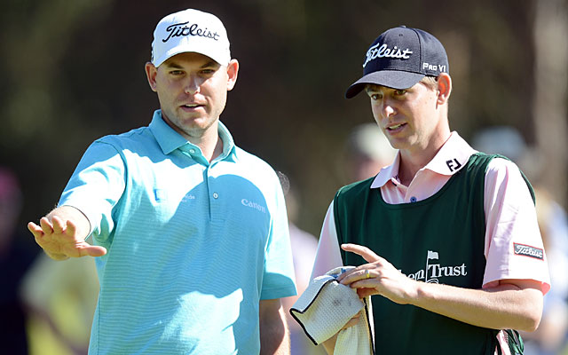 Bill Haas consults with caddie/older brother Jay Haas Jr. during the third round. (Getty Images)