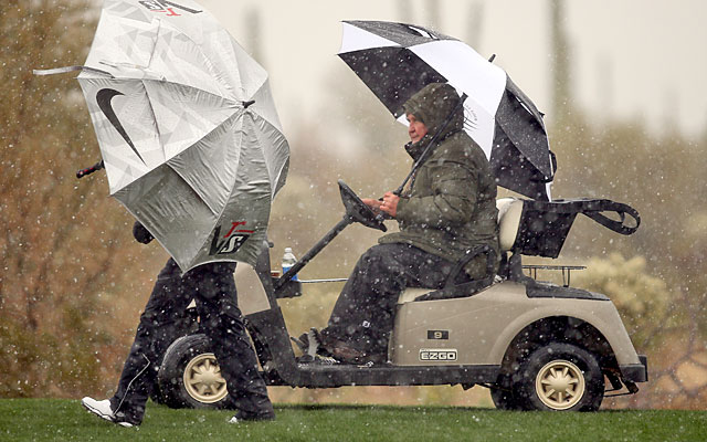 Snow, sleet and rain sent players, officials and fans scurrying for cover at Dove Mountain. (Getty Images)