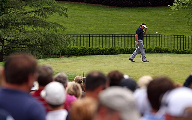 Mickelson tips his visor after sinking a birdie on No. 7. (Getty Images)