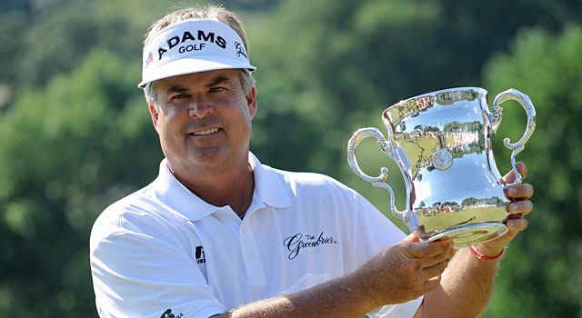 Kenny Perry hoists his hardware after a five-shot win at the Senior Open. (USATSI)