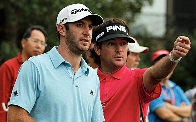 Dustin Johnson (left) and Bubba Watson try to determine where Johnson's tee shot landed. (Getty Images)