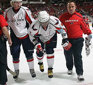 Ovechkin is helped off the ice after the collision. 