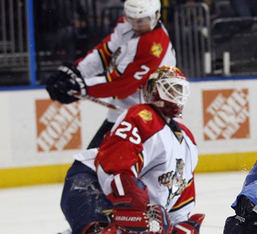 Ballard whacks his Panthers teammate Monday night. 