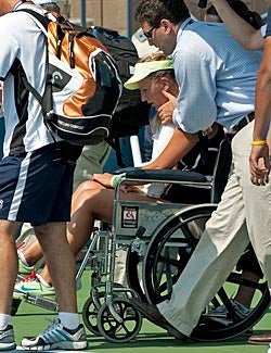Victoria Azarenka is taken off the court in a wheelchair. (Getty Images)