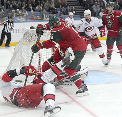 Hurricanes captain Eric Staal is taken down as he attempts to score from a tough position. (Getty Images)