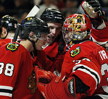 Patrick Kane (88) and Niklas Hjalmarsson react to a fine effort by Marty Turco in net in the shootout. (AP)
