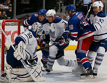 In a crowded crease, Ruslan Fedotenko pushes the puck past Leafs goalie Jonas Gustavsson for his first goal as a Ranger. (Getty Images)