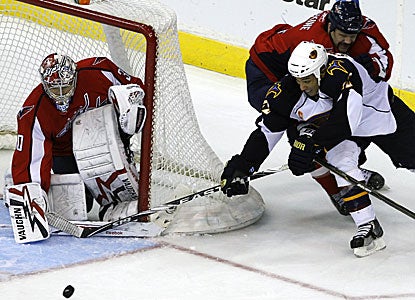 John Erskine, top right, holds Thrashers right wing Anthony Stewart off the puck and scores the tie-breaking goal for the Caps. (AP)