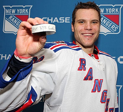 Defenseman Mike Sauer proudly shows the puck he used to score his first career goal in the NHL. (Getty Images)