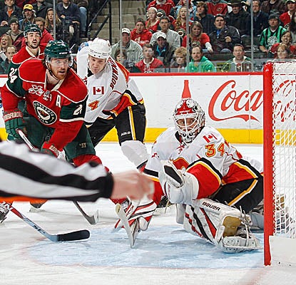 Martin Havlat hits the back of the net vs. Flames goalie Miikka Kiprusoff on Monday in Minnesota. (Getty Images)