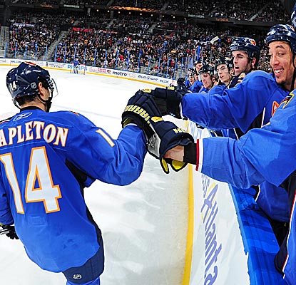 Tim Stapleton is congratulated by his Thrashers teammates after his goal in the shootout against the Bruins. (Getty Images)