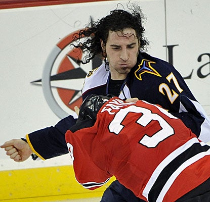Atlanta's Chris Thorburn lands a right punch on New Jersey's Mark Fayne during the second period. (AP)