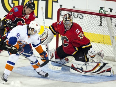 John Tavares lifts the puck past Henrik Karlsson while Jay Bouwmeester tries to stop him. (AP)