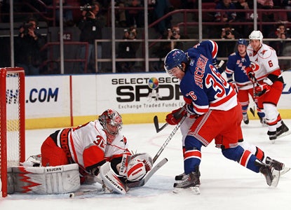 Cam Ward makes a stop on Mats Zuccarello in the second period but doesn't stop his overtime winner. (Getty Images)
