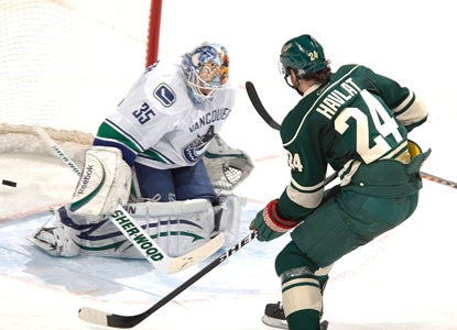 Martin Havlat slips a shot past Vancouver goalie Cory Schneider in the Wild's win. (Getty Images)