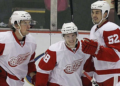 Prospect Cory Emmerton (center) makes the best of getting a chance to play and scores his first goal in his NHL debut. (US Presswire)