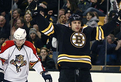 While Milan Lucic celebrates his goal for Boston, Michael Frolik can't hide his disappointment in the background. (AP)