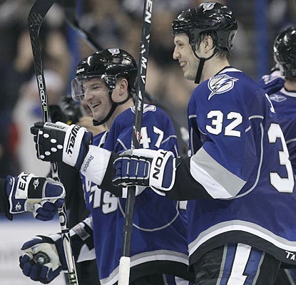 The Lightning's Marc-Andre Bergeron (47) receives plenty of love from teammates after he scores the game winner in OT.  (AP)