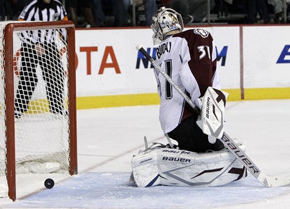 Avalanche goalie Peter Budaj watches as Predators defenseman Cody Franson's shot rolls in for a third-period goal. (AP)