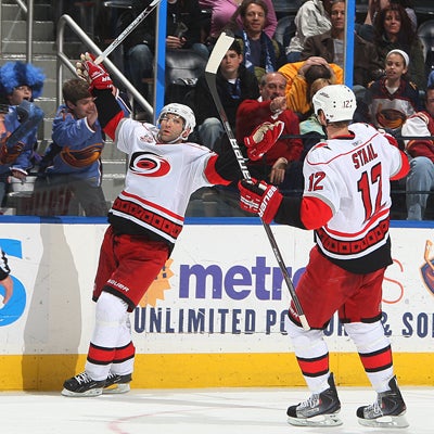 Erik Cole (left) throws his hands up in celebration after scoring the go-ahead goal with 1:19 left in the third.  (Getty Images)