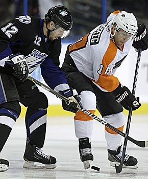 Kris Versteeg, battling with ex-Flyer Simon Gagne, gives Philly even more flexibility up front. (AP)