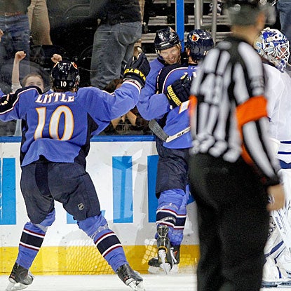Ron Hainsey (facing camera), is congratulated by teammates after scoring the game-winning goal. (AP)