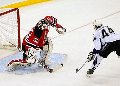 Martin Brodeur denies Nate Thompson a one-on-one chance, making one of his 15 saves on the night. (Getty Images)