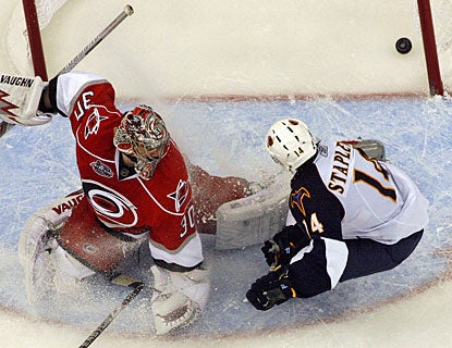 Tim Stapleton directs the puck past goalie Cam Ward on a 2-on-1 rush with Ron Hainsey. (AP)