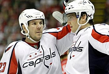 Scott Hannan (left) and the Caps haven't missed a beat with star Alex Ovechkin (right) sidelined. (AP)