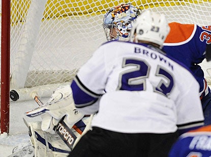 Dustin Brown beats Nikolai Khabibulin on the short side in the second period, during which he scores both of his goals.  (AP)
